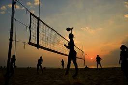Fototapeta beach volleyball silhouette at sunset , motion blurred