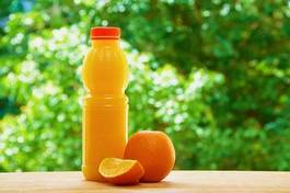 Naklejka orange and juice on the table