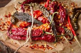 Fototapeta dry  chili pepper on a wooden background