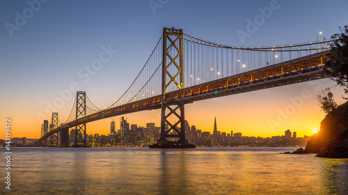 Naklejka San Francisco skyline with Oakland Bay Bridge at sunset, California, USA