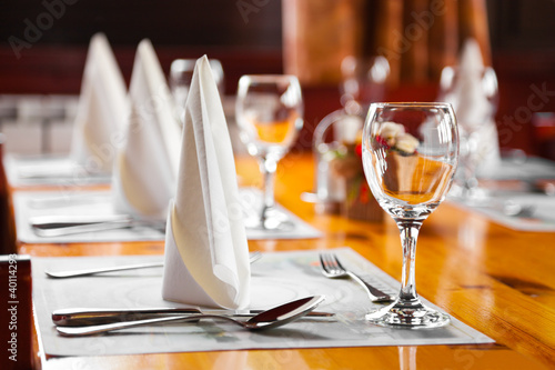 Naklejka Kieliszki i talerze na stole w restauracji
