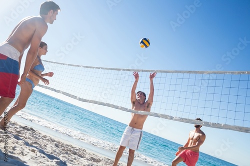 Fototapeta Friends playing volleyball
