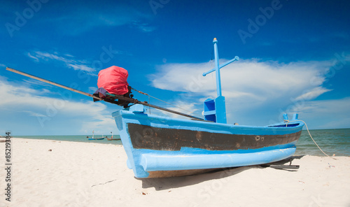 Naklejka Wooden fishing boat on the beach.