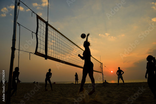 Fototapeta Beach volleyball silhouette at sunset , motion blurred
